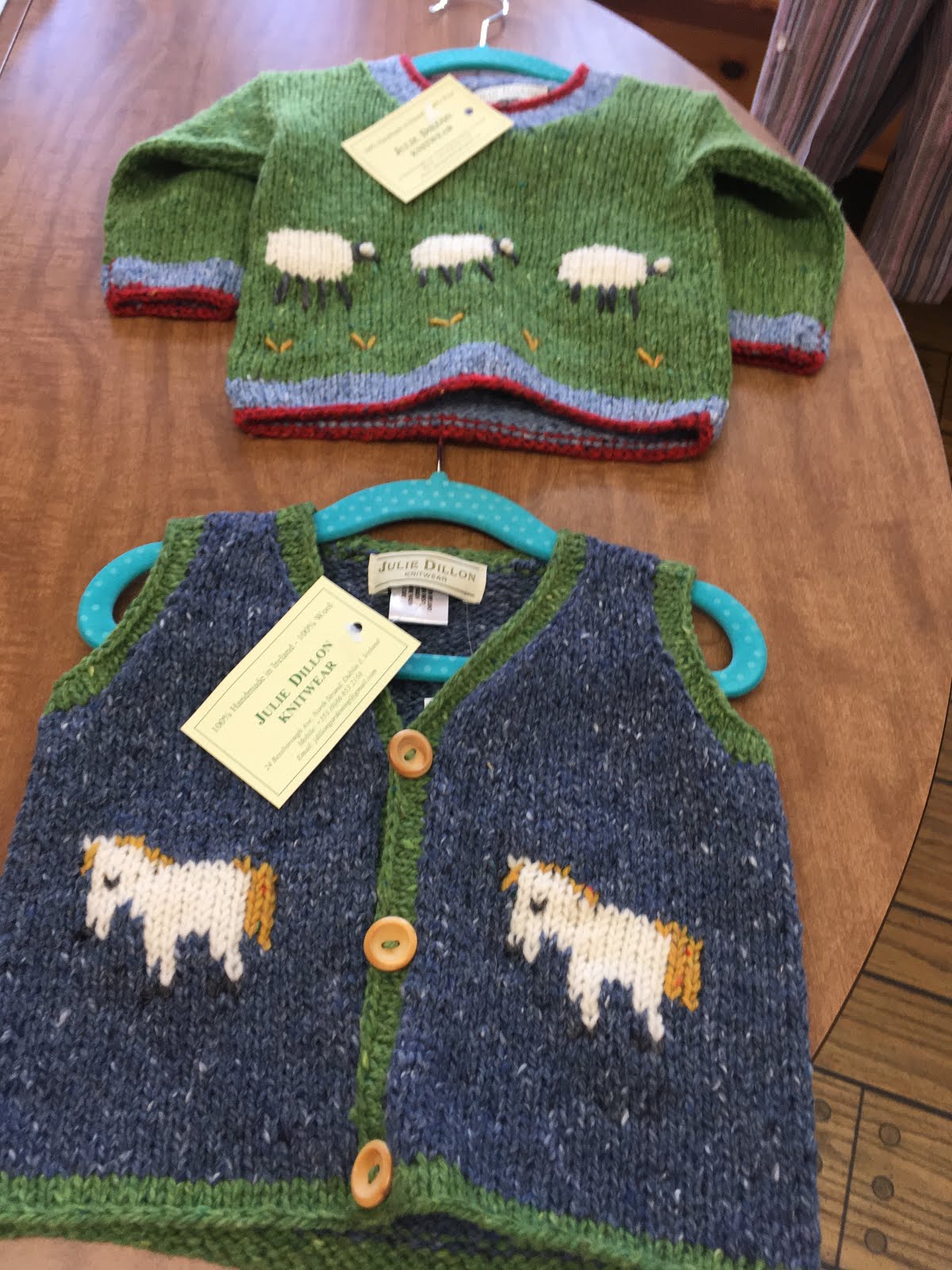 Green hand knit children's cardigan with sheep and cow motifs